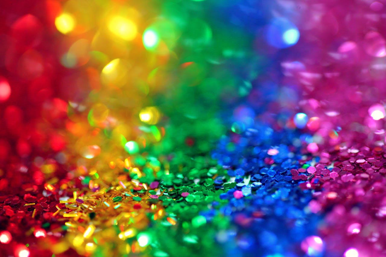 Colorful bokeh effect with vibrant rainbow glitter, perfect for festive backgrounds.